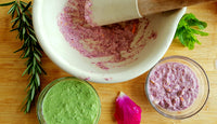 Coloured herb skincare in white cermic mortar and pestle